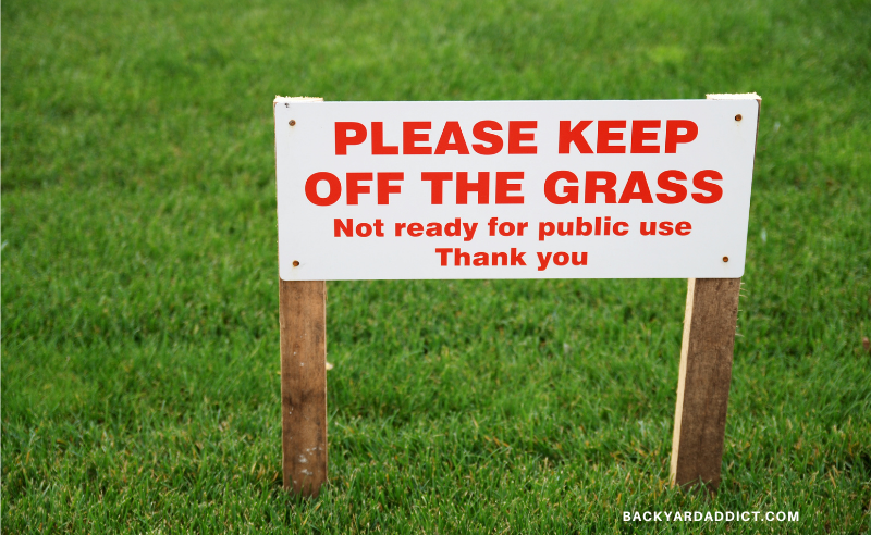 sign on grass says, Keep off grass. Not ready for public use yet.