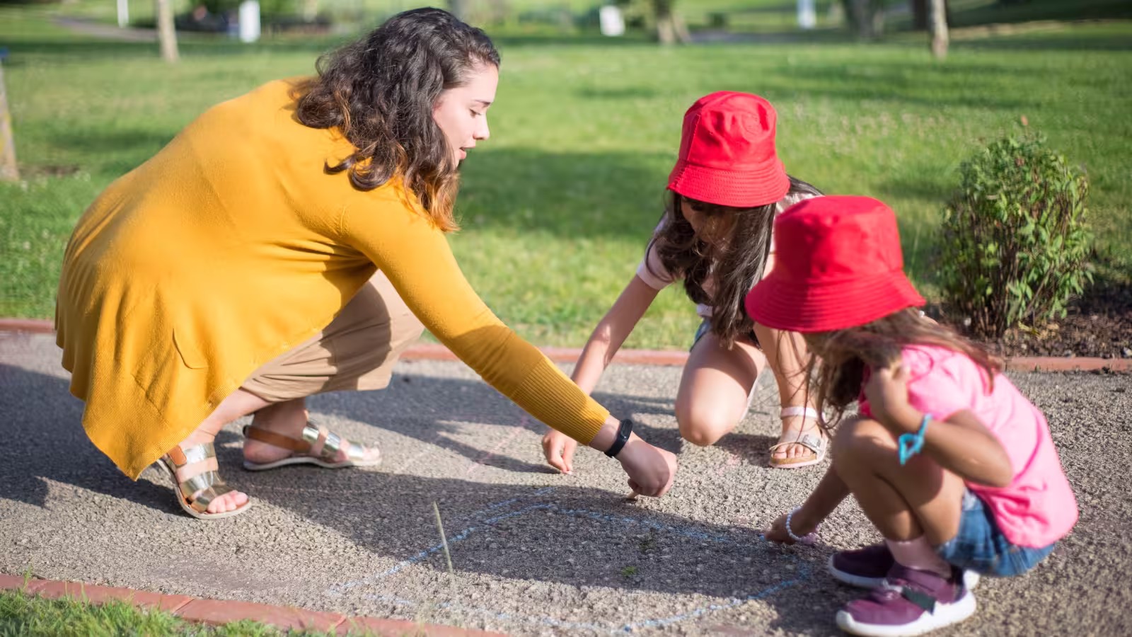 Mom and kids using sidewalk chalk