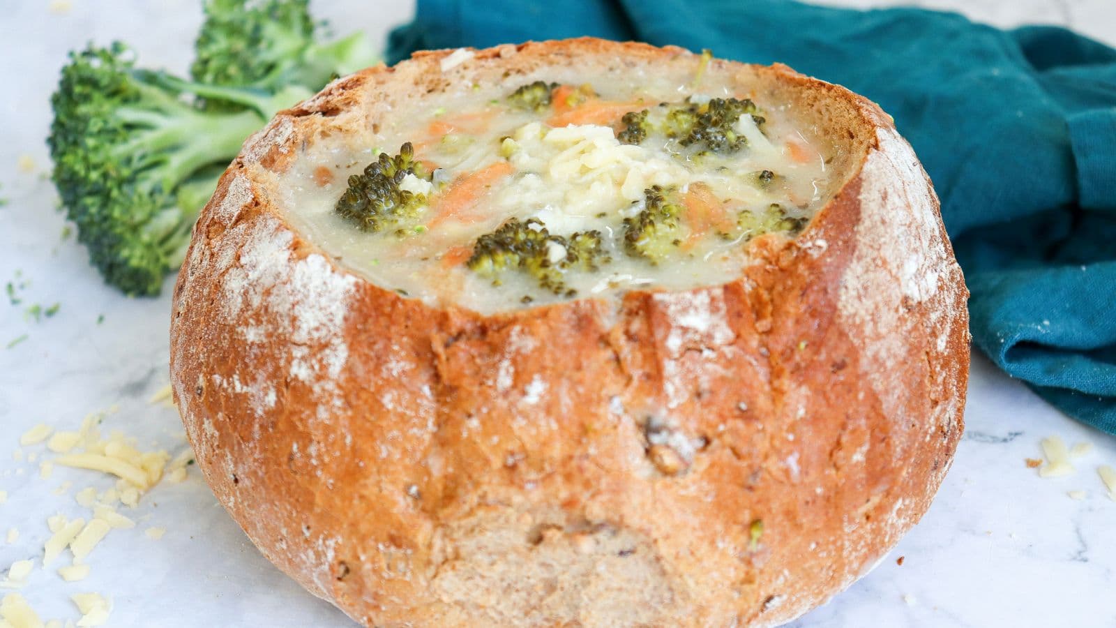 broccoli cheddar soup served in a round bread bow