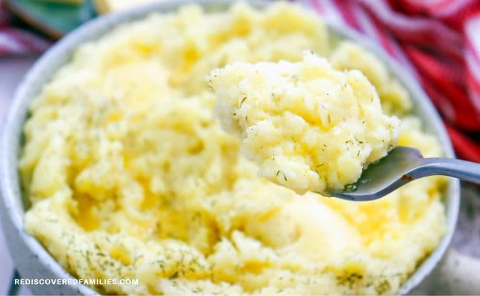 A bowl of perfect creamy mashed potatoes with a fork