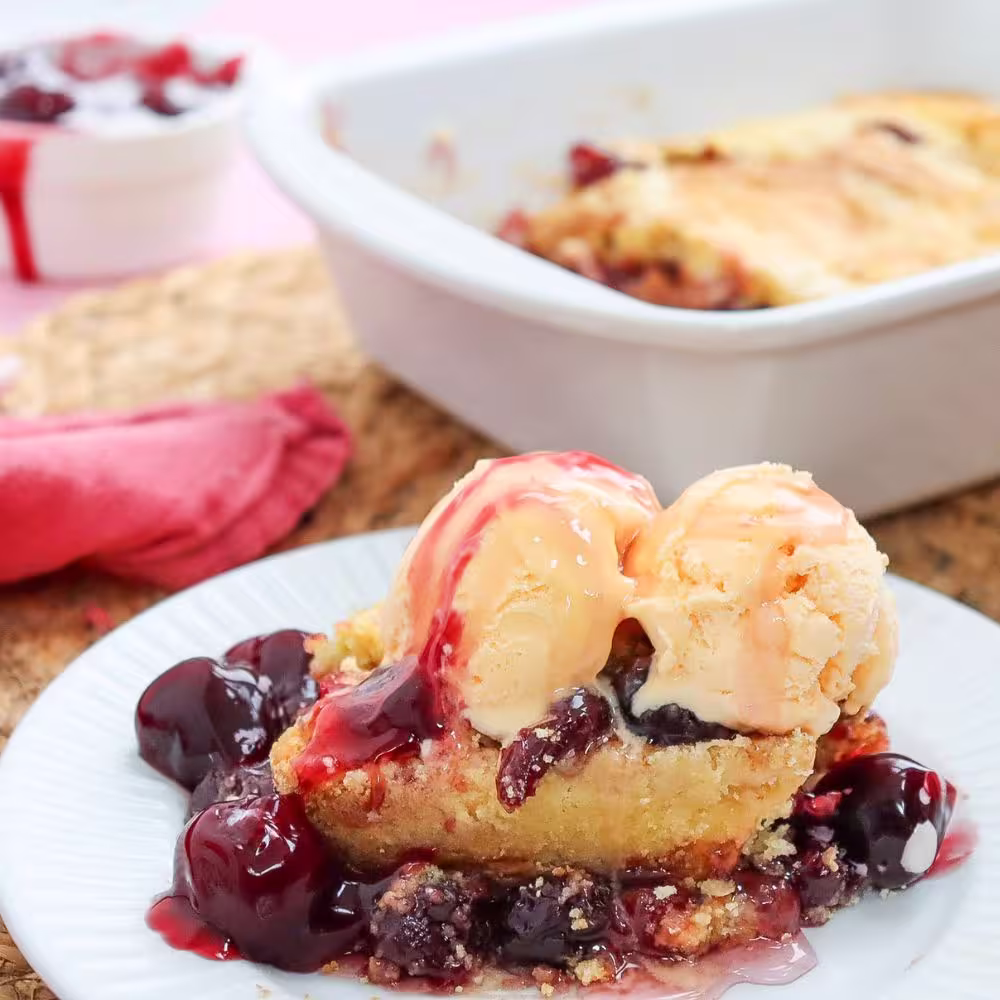 a serving of cherry dump cake with ice cream