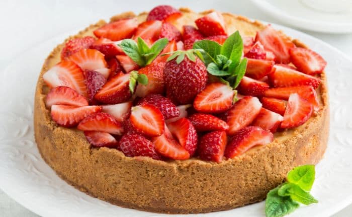 strawberry cheesecake on a decorative white plate